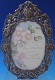 Picture Frame w/ 2-cherubs & basket of flowers  ceramic tile can be removed  w/ fork stand for tabletop and original ring at top for wall hanging  8 3/4